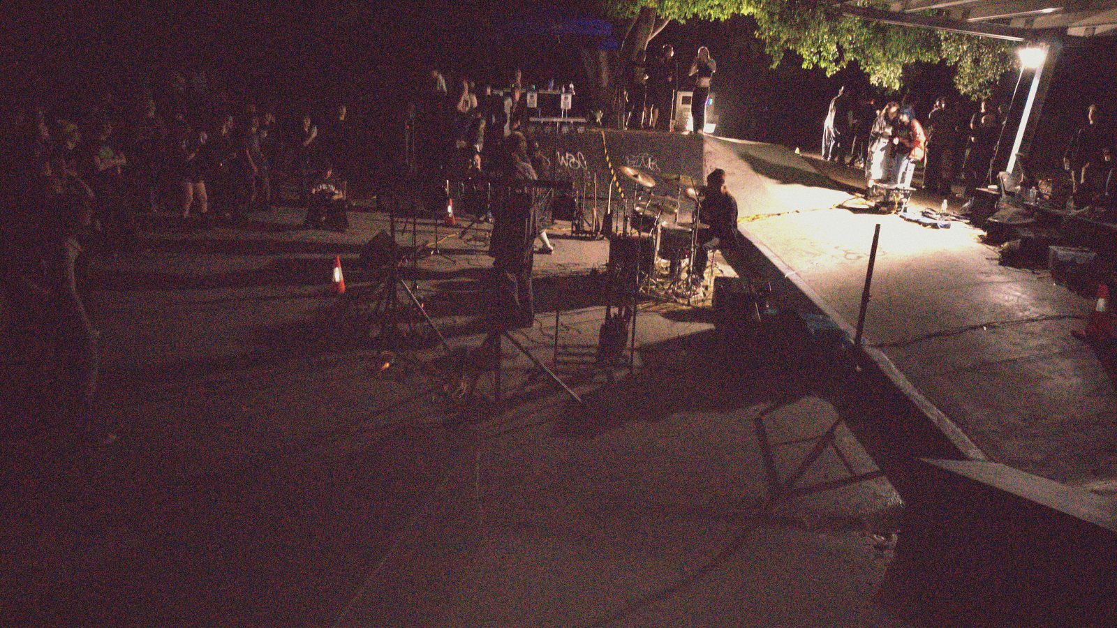 The bowl at Thornlands skatepark at dusk, the crowd gathering in one worklight